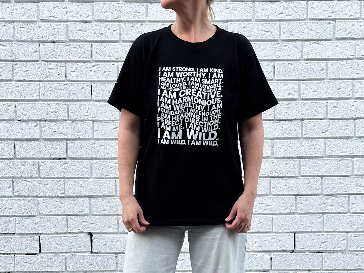 A black boyfriend-fit women's tee printed with a sea of positive affirmations rooted in the Wildfemmes values. Wear your worth. By Emma Maggs.